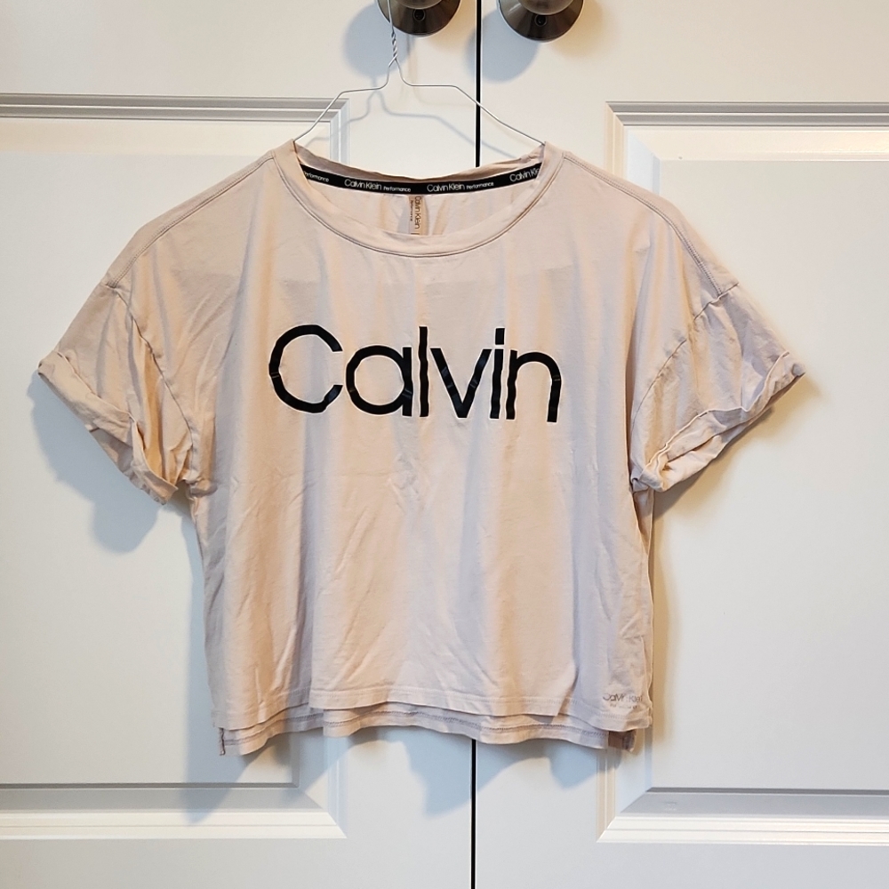 Calvin Klein performance loose-fit crop-top, light tan color with black logo